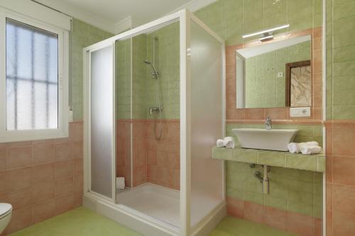 a bathroom with a shower and a sink at Casa Las Niñas in Olvera