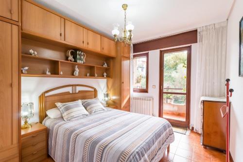 a bedroom with a large bed with wooden shelves at Mila Somo in Somo