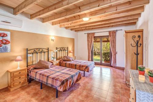 a bedroom with two beds in a room at Finca Sa Pova in Alcudia