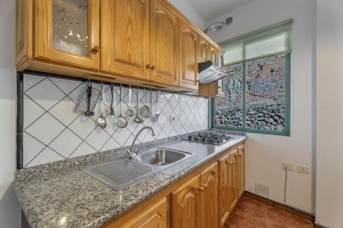 a kitchen with a sink and a counter top at Apartamento Nayara A in Calera