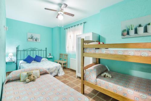 a childrens bedroom with two bunk beds and blue walls at Capricho in Cieza