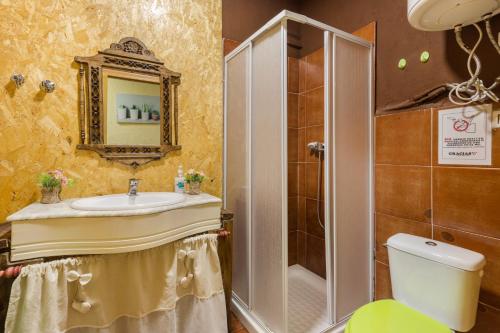 a bathroom with a sink and a shower and a toilet at Capricho in Cieza