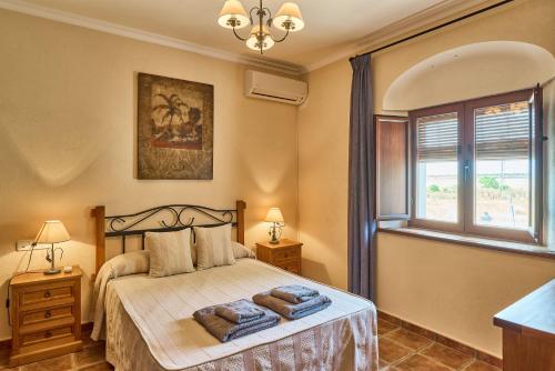 a bedroom with a bed with two towels on it at Apartamentos Valsequillo Córdoba in Valsequillo