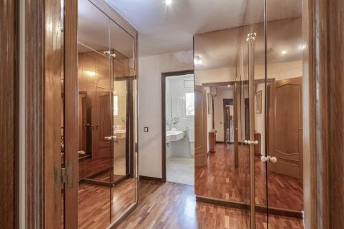 a bathroom with a glass shower and a sink at Villa Masnou in El Masnou