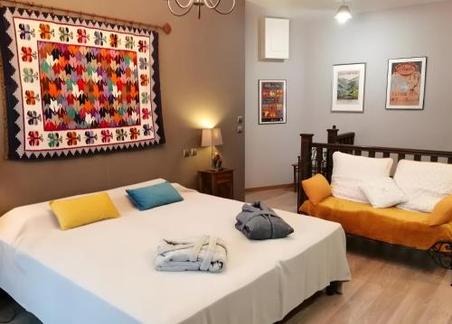 two beds in a room with a rug on the wall at Maison des Princes de Monaco in Vic-sur-Cère