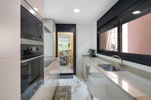 a kitchen with a sink and a counter top at Villa Can Camarassa in Cervelló