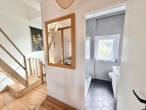 a bathroom with a toilet and a mirror at Résidence Gaïa - Etretat in Étretat