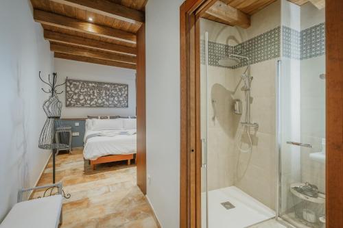a bathroom with a shower and a bedroom at La Antigua Taberna - Nieva in Nieva