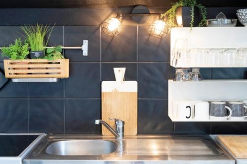 a kitchen with a sink and a counter top at Charmant T2 centre Capbreton in Capbreton