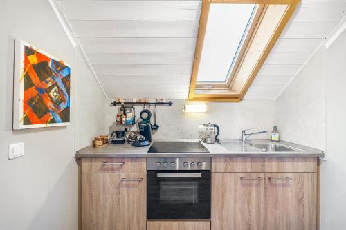 a kitchen with a sink and a stove at Haus am Bach in Benediktbeuern
