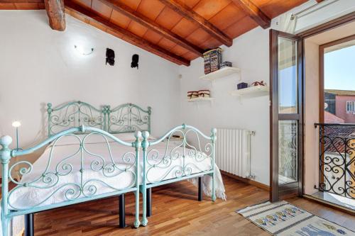 a bedroom with a blue bed in a room at Camere La Ro Ca- Telti in Telti