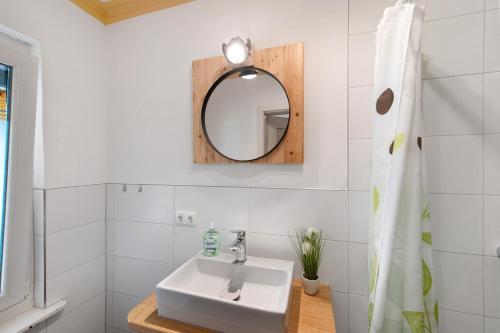 a bathroom with a sink and a mirror at Ferienhaus am Rande der Lewitz in Garwitz
