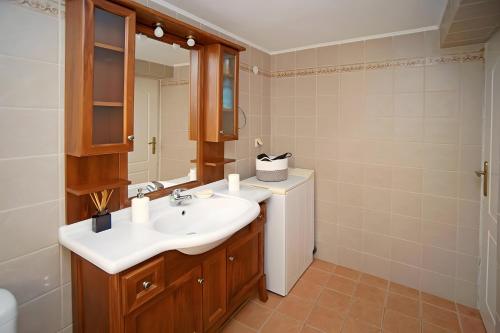 a bathroom with a sink and a mirror at A View From The Attic Window in Kyparissia