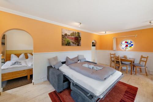 a bedroom with a bed and a dining room at Ferienhaus am Rande der Lewitz in Garwitz