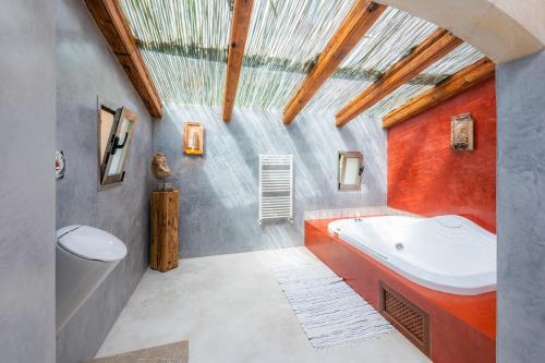 an attic bathroom with a tub and a sink at Can Xisco in Artá