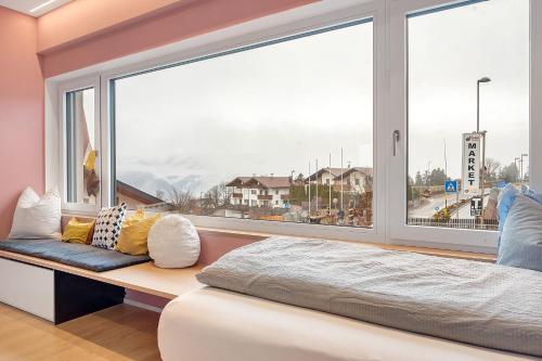 a bed in a room with a large window at Casa Zar Ferienwohnung in Verano