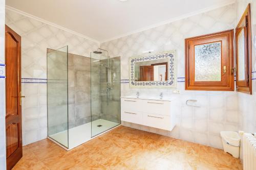 a bathroom with a shower and a sink and a mirror at Tomymar in Cala Ratjada