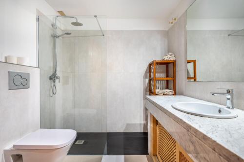 a bathroom with a sink and a toilet and a shower at Vistasol Port de Soller in Sóller