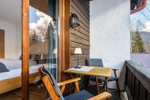 a room with a small table and chairs on a balcony at Fewo Am Steinbach - Lofer in Reit im Winkl