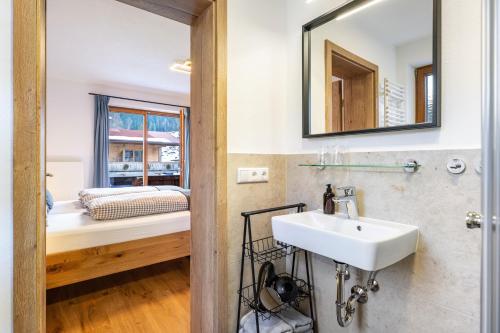 a bathroom with a sink and a mirror at Fewo Am Steinbach - Lofer in Reit im Winkl