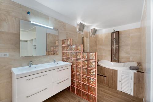 a bathroom with a white sink and a mirror at Beach Holidays in Adeje