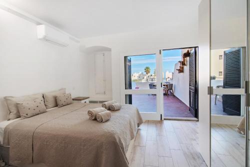 a bedroom with a bed and a view of the ocean at White Studio and Terrace in Albufeira