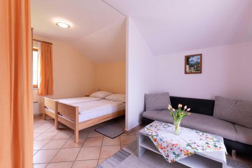 a small room with a bed and a couch at Appartment Isabelle Home in Hermagor