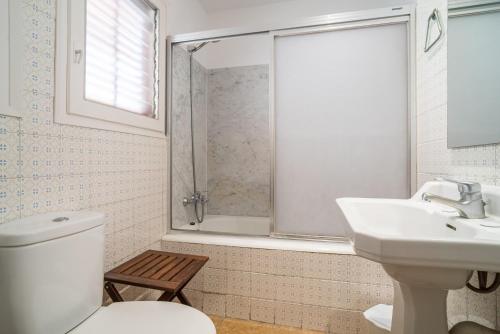 a bathroom with a toilet and a sink and a shower at Canet beach 3 in Canet de Mar