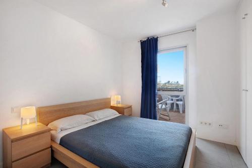 a bedroom with a bed and a window with a view at Edificio Los Martines in El Médano