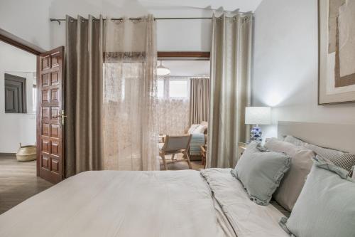 a bedroom with a bed and a chair in a room at Casa Steffi in Arona