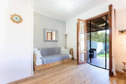 a bedroom with a bed and a sliding glass door at Villa Balbi in Torre delle Stelle