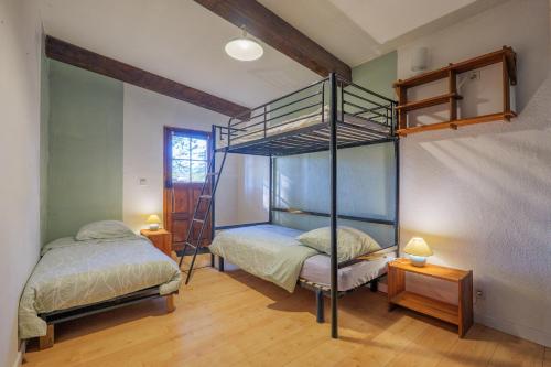 a bedroom with two bunk beds and a ladder at Gîte Des Louveteaux in Banne