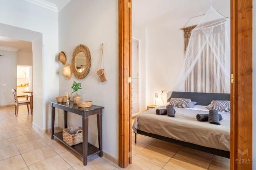 a bedroom with a bed and a mirror at Casa Llimoner con piscina in Sant Llorenç des Cardassar