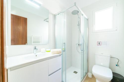 a bathroom with a shower and a sink and a toilet at Sa Barca - Can Ferrando in Cala Santanyi