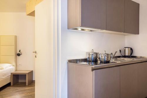 a kitchen with a sink and a counter top at Apartment Ön Residence Bun Ste in San Vigilio Di Marebbe