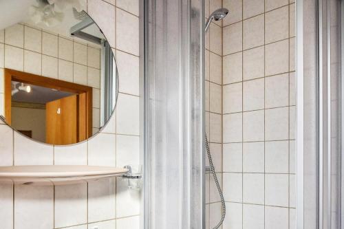 a bathroom with a shower and a sink and a mirror at Ferienwohnung 4 in Bernkastel-Kues