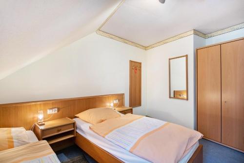 a small bedroom with two beds and a mirror at Ferienwohnung 4 in Bernkastel-Kues