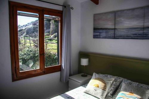 a bedroom with a window and a bed and a bed sidx sidx sidx at Costa Arenal - Biniplaya in Arenal d'en Castell
