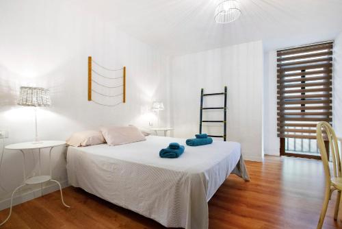 a bedroom with a bed with two blue towels on it at Casa Brando in Corralejo