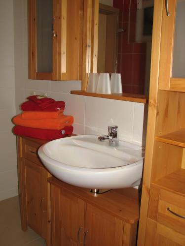 a bathroom with a white sink and a mirror at Ferienhaus Enger in Saalfeld