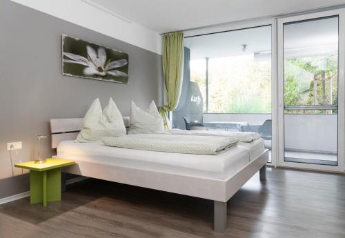 a bedroom with a bed and a large window at Apartment 4 in Rielasingen-Worblingen