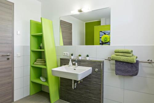 a bathroom with a sink and a mirror at Apartment 4 in Rielasingen-Worblingen