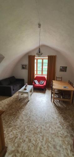 a living room with a couch and a table at Gite des pecheurs, Gorges du Tarn in Mostuéjouls