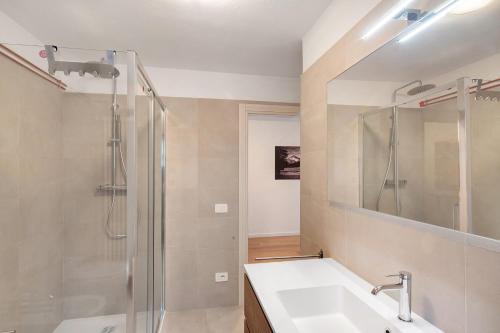 a bathroom with a sink and a shower at Ciasa Civetta in Piaia