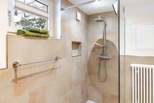 a shower with a glass door in a bathroom at Ferienwohnung Am Schleifenbach 2 in Saalfeld