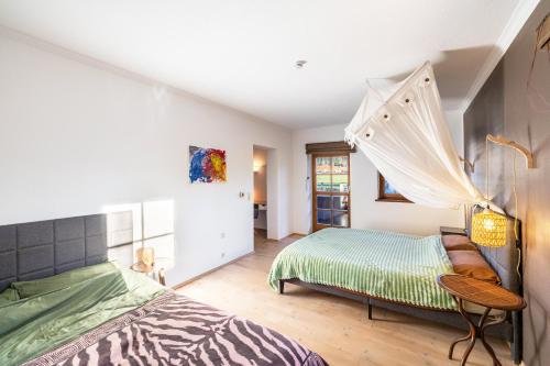 a bedroom with a bed with a canopy at Haus am Bach in Benediktbeuern