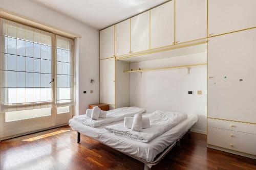 a bedroom with two beds and a large window at Villa Ottaviano By Immobilux in Arco