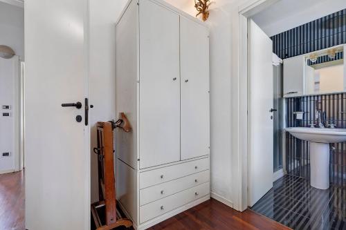 a bathroom with white cabinets and a sink at Villa Ottaviano By Immobilux in Arco