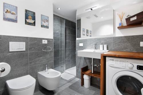 a bathroom with a washing machine and a sink at A casa di Anna in Madesimo