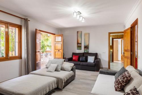 a living room with two beds and a couch at Finca Can Lluc in Alaró